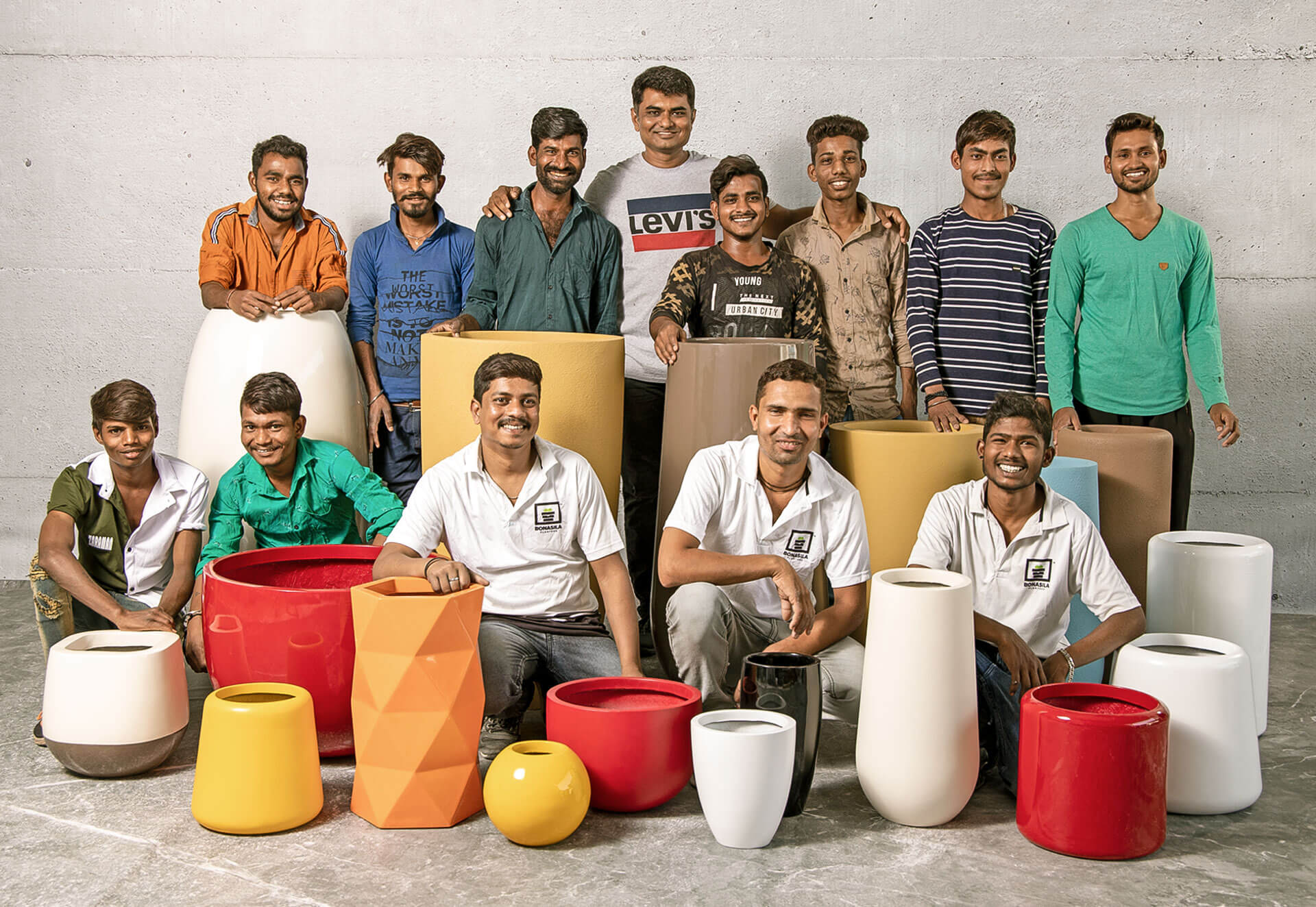 Team bonasila standing together with planters from it's collection